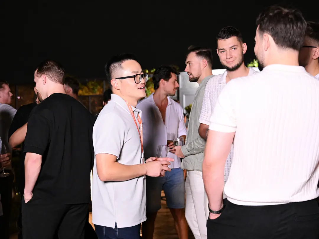 Founders talking on a rooftop at a Reign event in Bangkok
